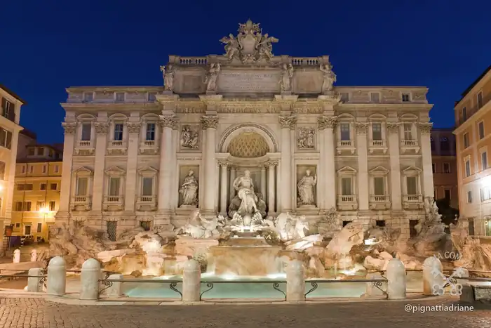 A fonte encostada na fachada do Palazzo Poli, com as inscrições do Papa Clemente XII e o Papa Bento XIV.